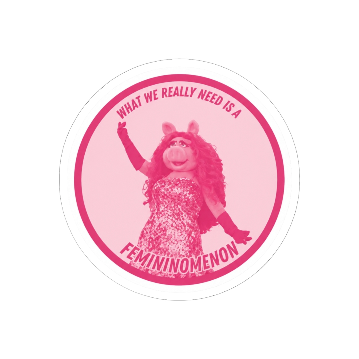 Pink round sticker with a white border featuring a pink pig character with the text "What we really need is a femininomenon" - Official stickers merchandise
